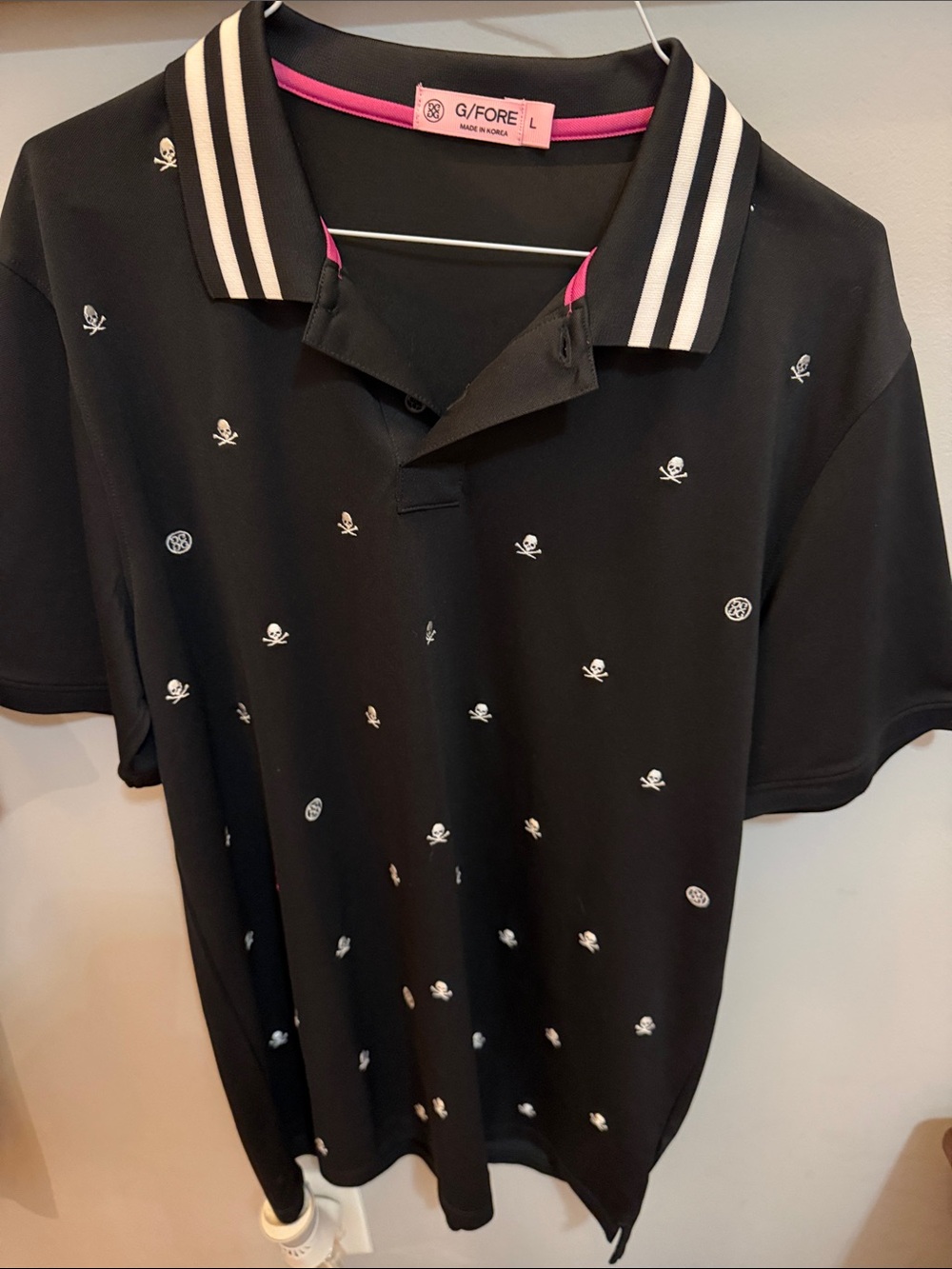 G/FORE Black Polo with White Skull Motif and Pink Trim